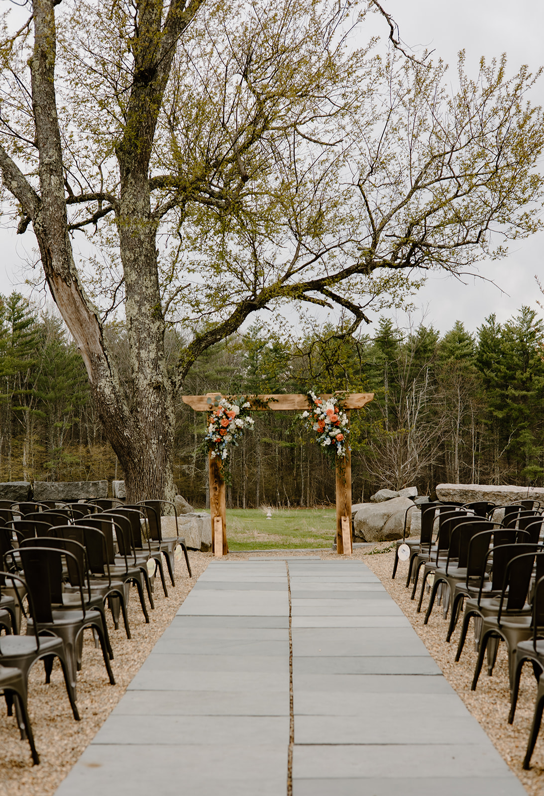 Rustic outdoor wedding ceremony at The Barn at Powder Major's Farm in Madbury, New Hampshire.