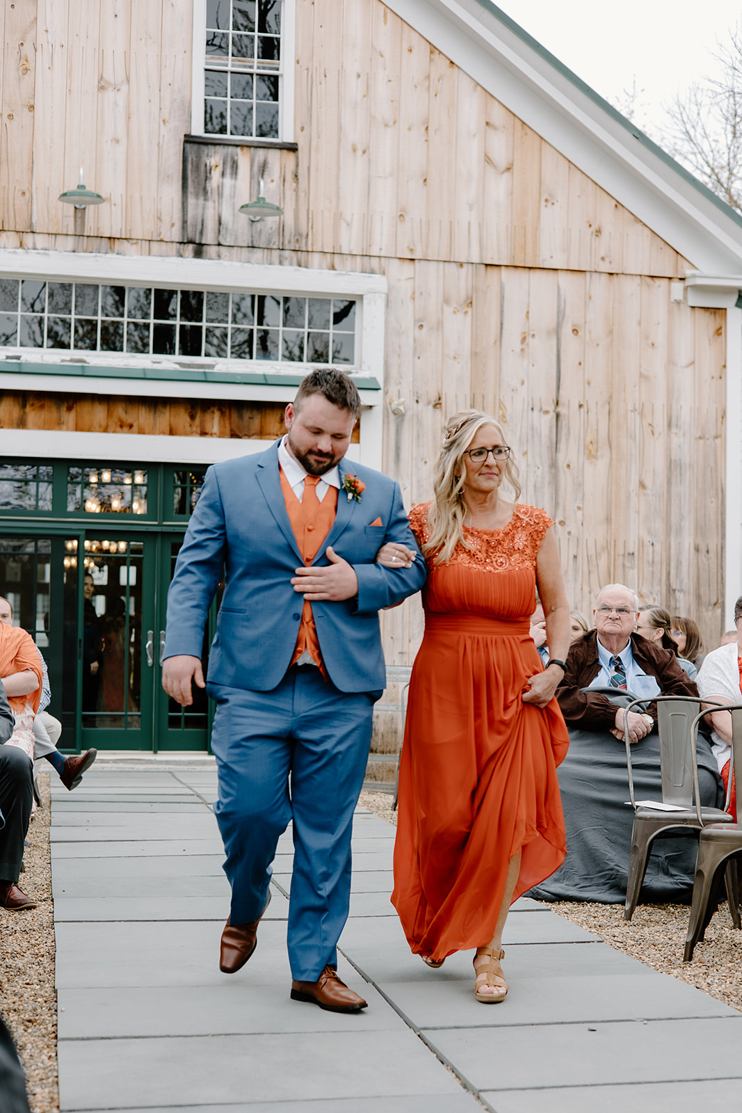 Groom and mother walking down the aisle outside Powder Major's Barn in Madbury, New Hampshire.