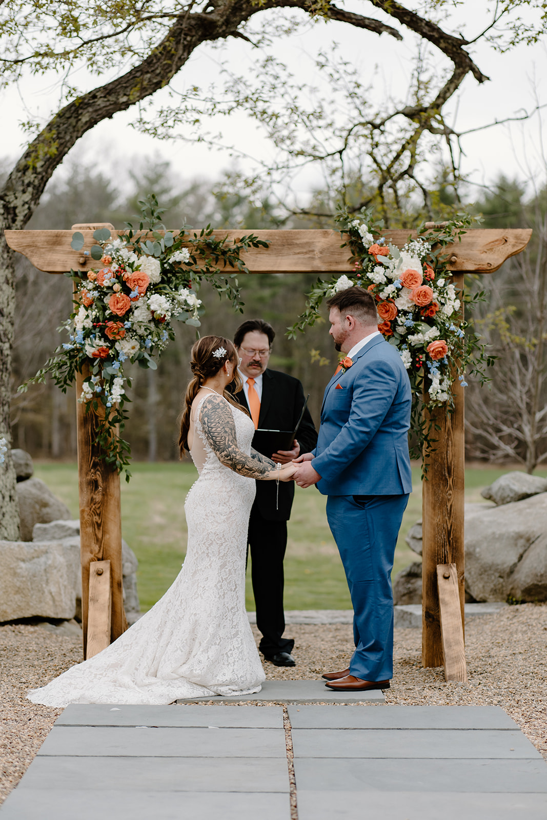 Outdoor rustic ceremony at Powder Major's Farm in Madbury, New Hampshire with a rustic altar and flowers.
