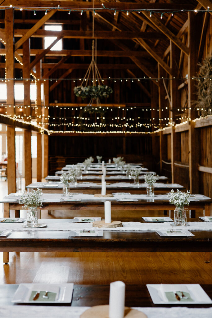 Romantic barn wedding with string lights at Powder Major's Farm in Madbury, New Hampshire.