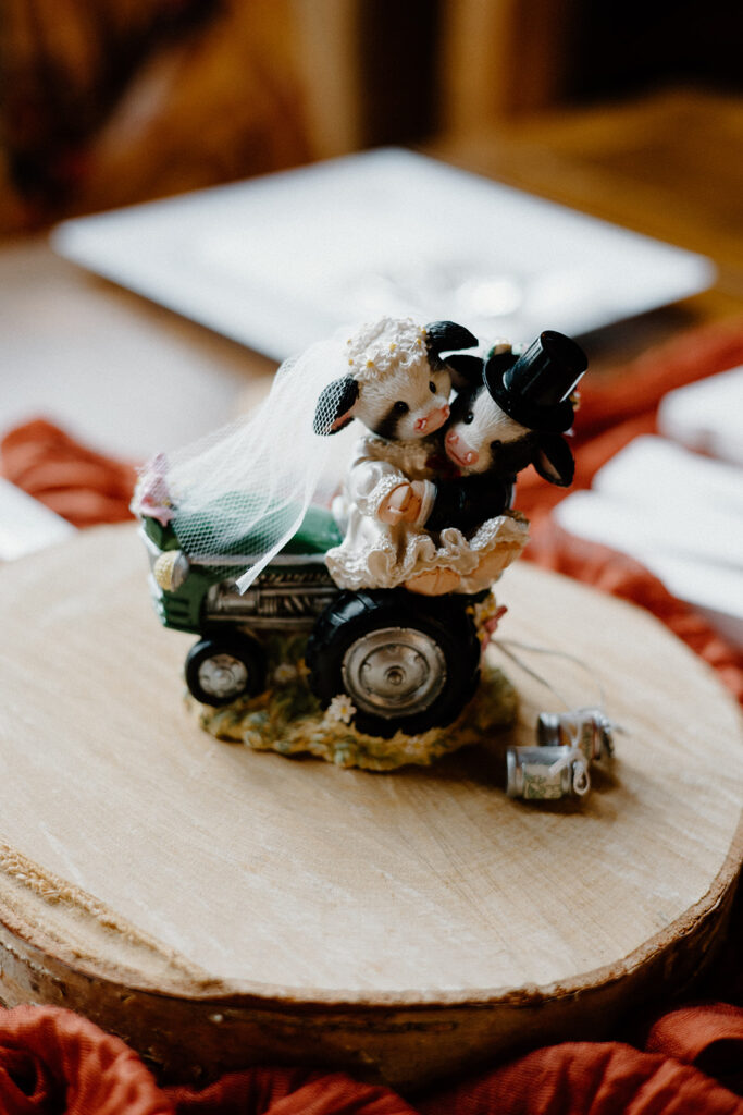 Rustic wedding cow cake topper.