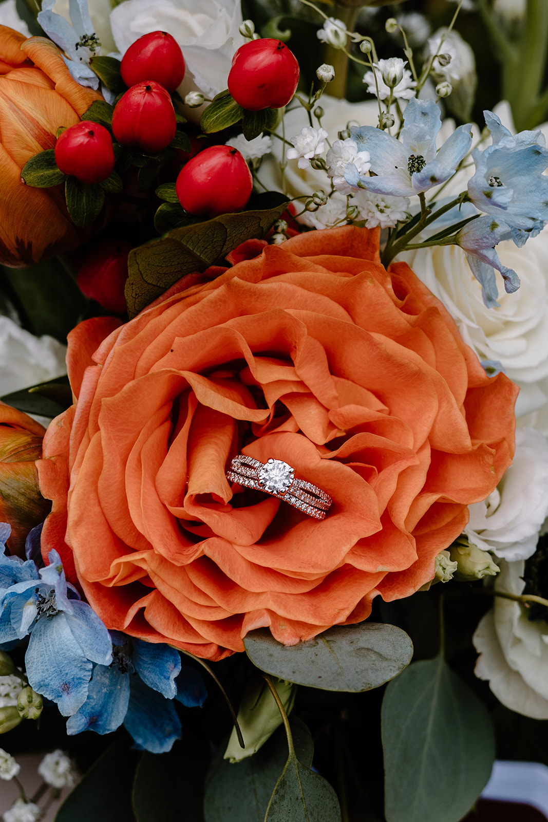 Wedding ring up close detail photo inside an orange flowers.