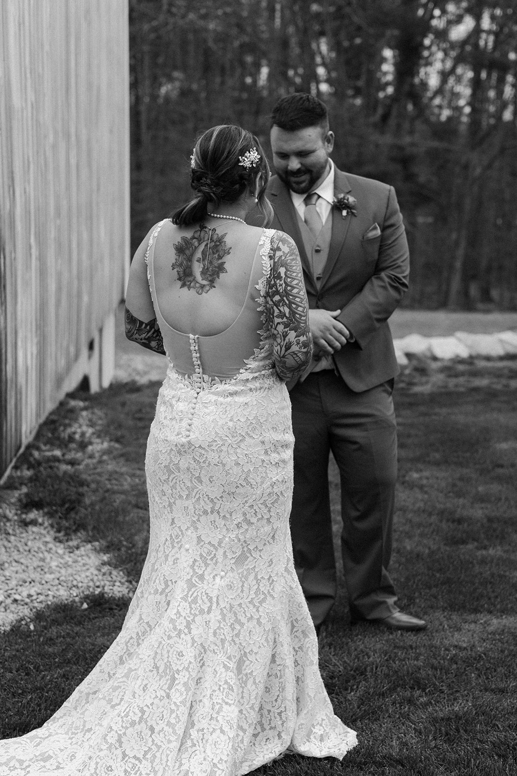 A sweet black and white photo of a groom's first look at his bride.
