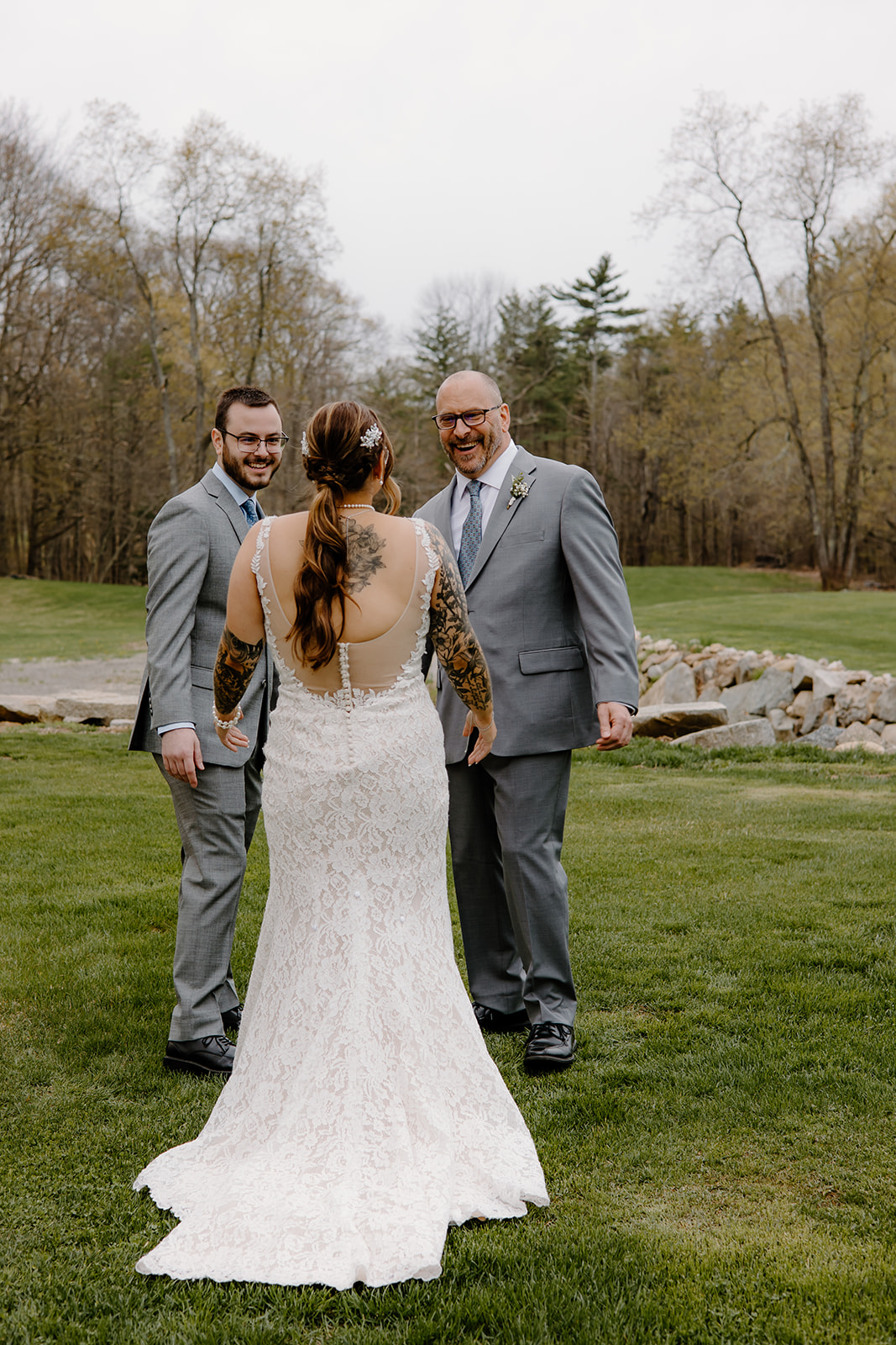 First look reactions of a bride with her brother and father.