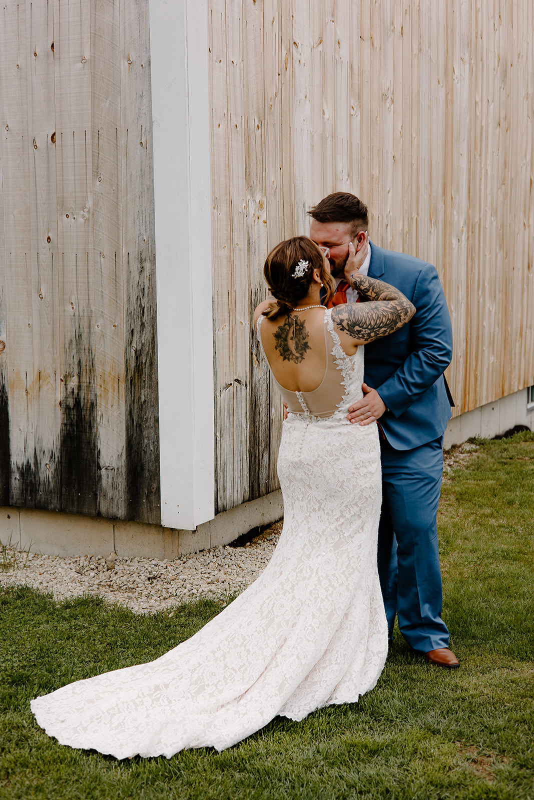 Bride and groom sharing a kiss after their first look outside of The Barn at Powder Major's Farm in New Hampshire.