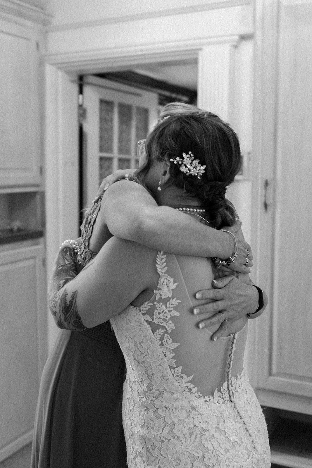 Bride hugging her mom after getting ready.