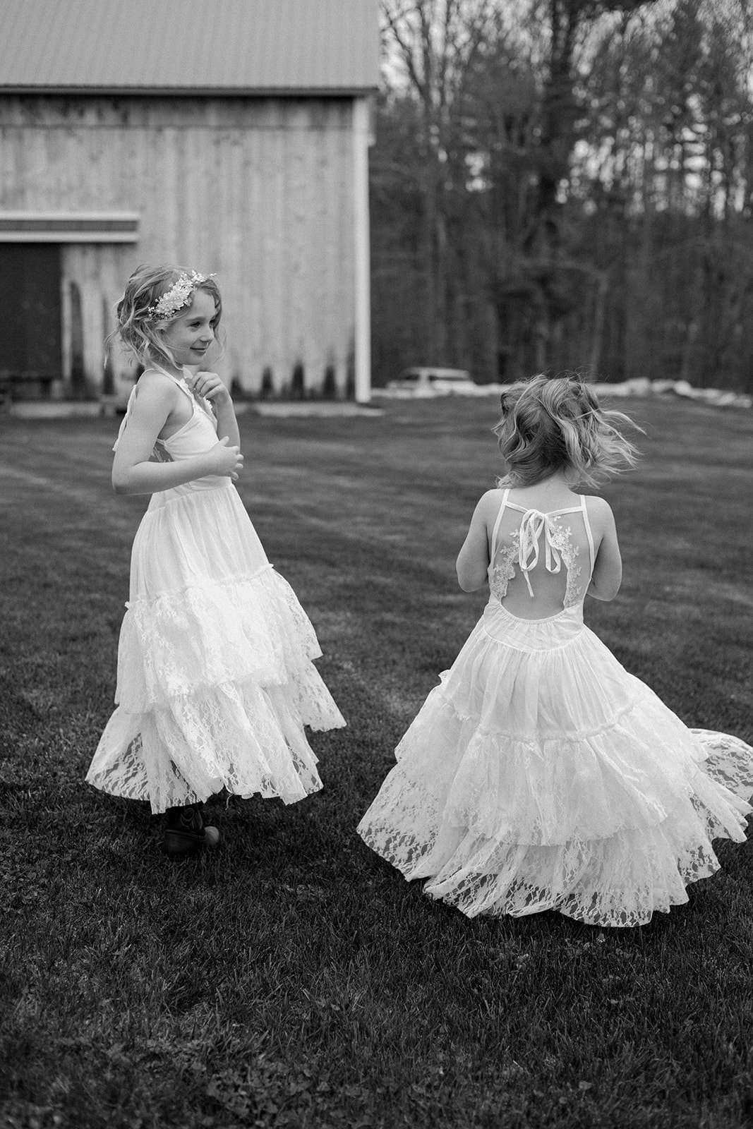Black and white photo of flower girls dancing.