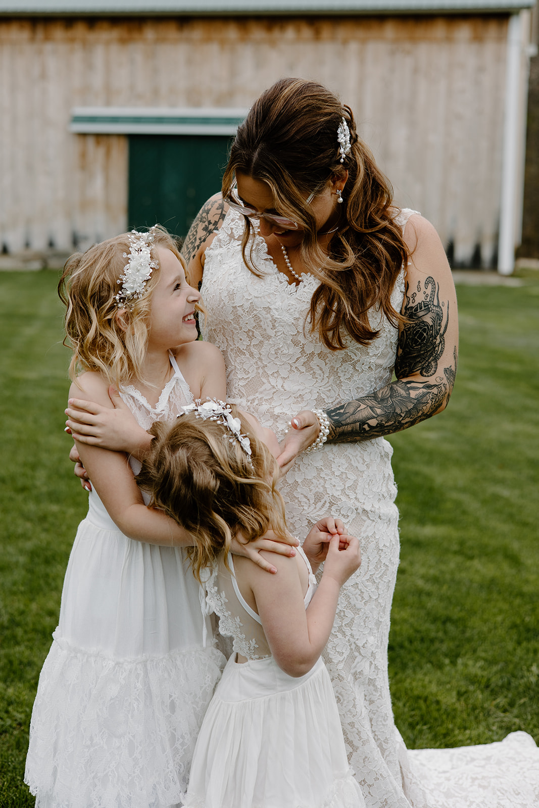 Bride sharing a sweet moment with her two flower girls.