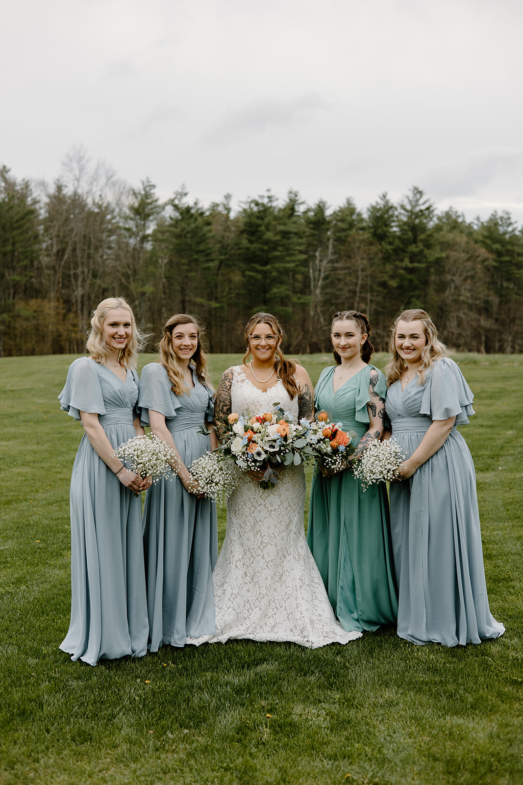 Bride and bridesmaid portrait with long blue chiffon dresses.