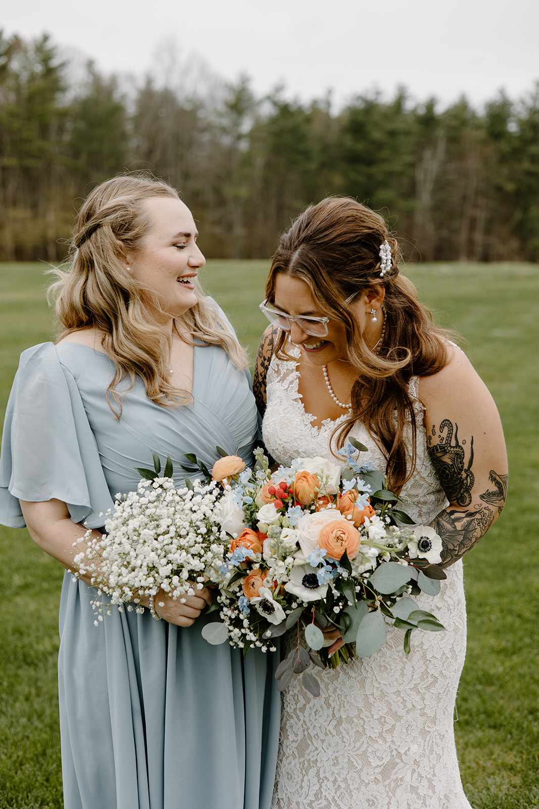 Bride and bridesmaid portrait with bouquets.
