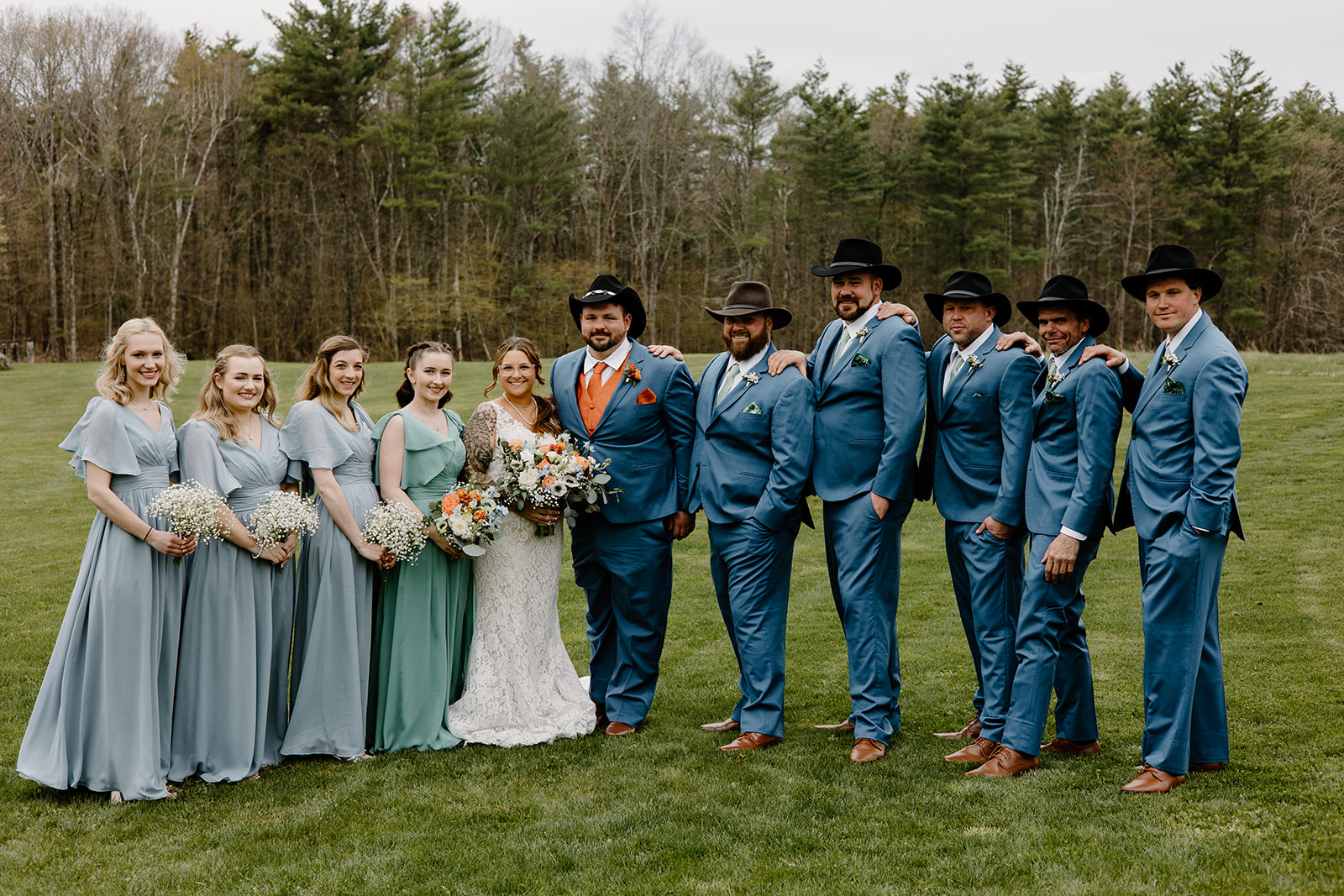 Rustic orange and blue wedding party portrait.