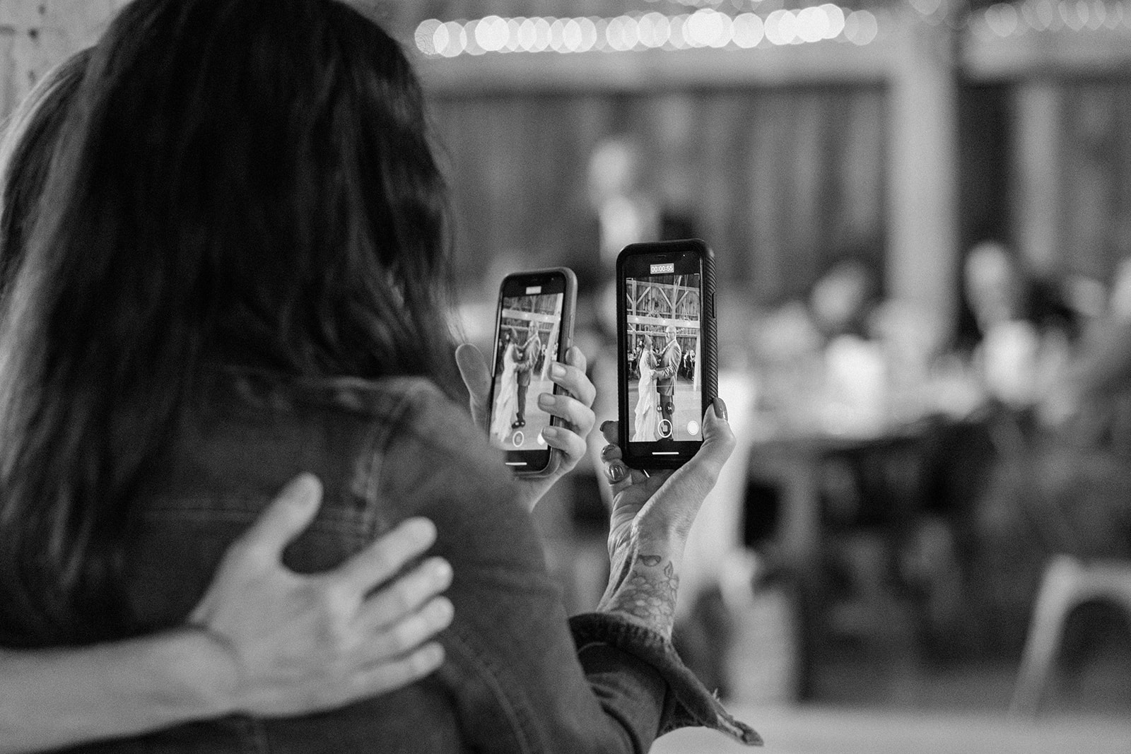 Mom and step-mom recording the bride and her dad dancing.