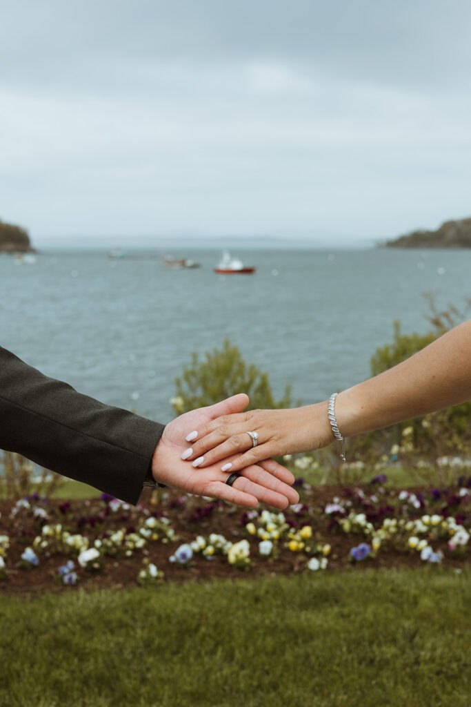 Maine oceanfront wedding bride and groom ring portrait.