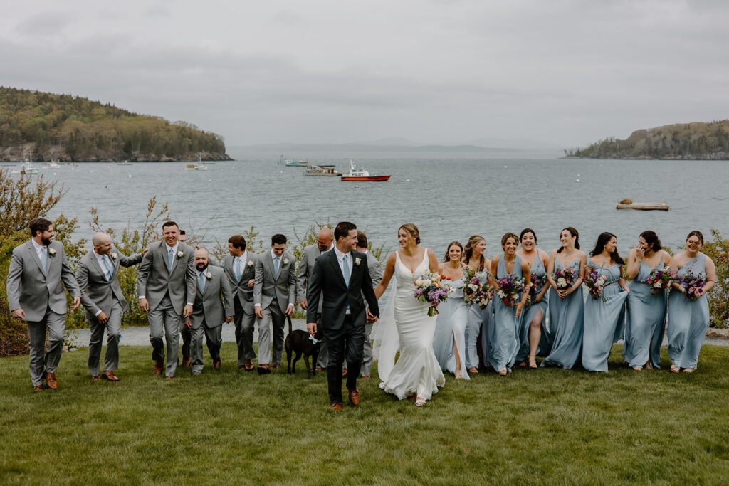 Coastal Maine wedding bridal party with long, flowy blue bridesmaid dresses.