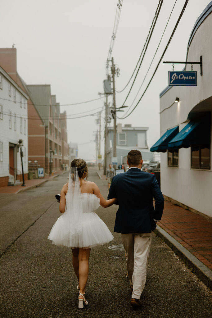 Couple dressed up and walking down Old Port in Portland, Maine.