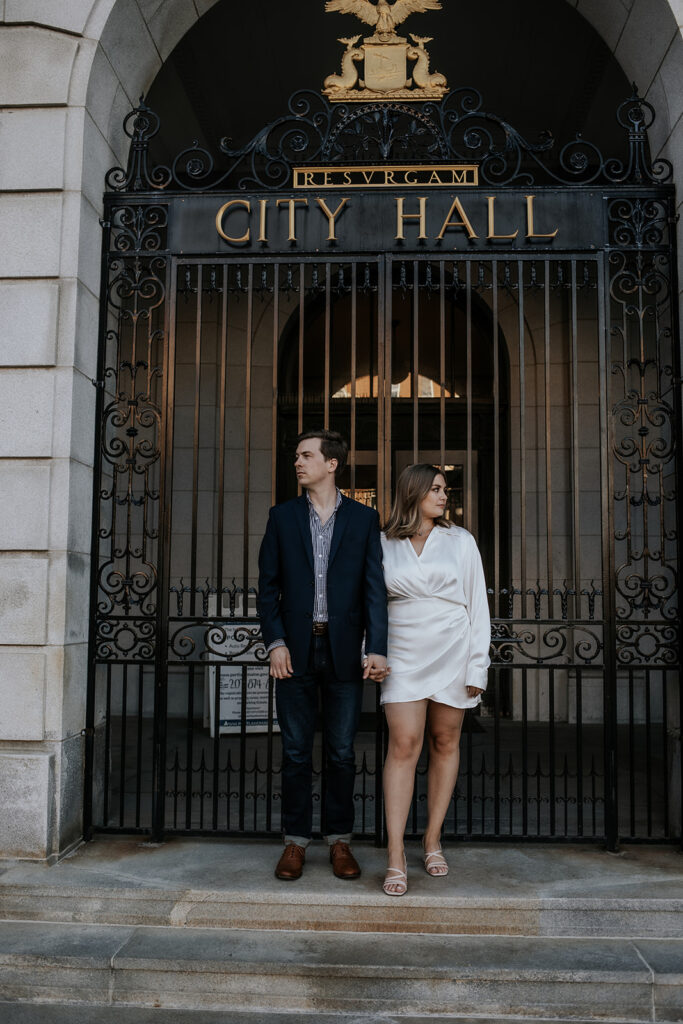 Chic couple posing outside Portland Maine City Hall.