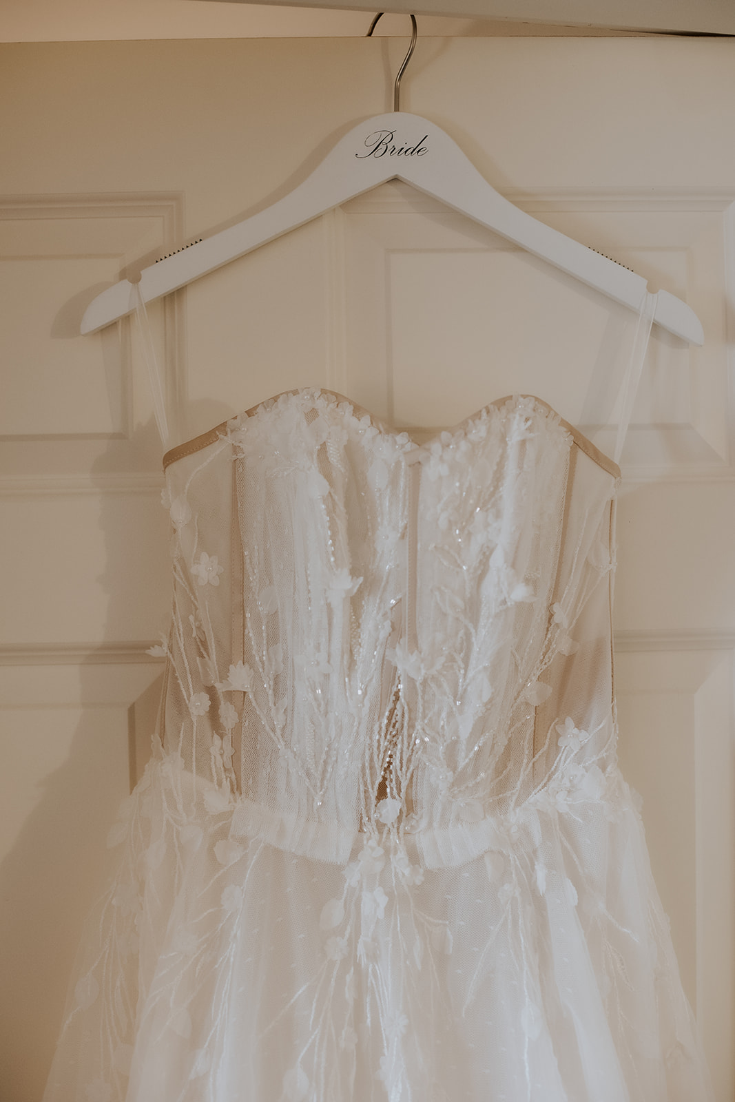 Wedding dress hanging detail photo.