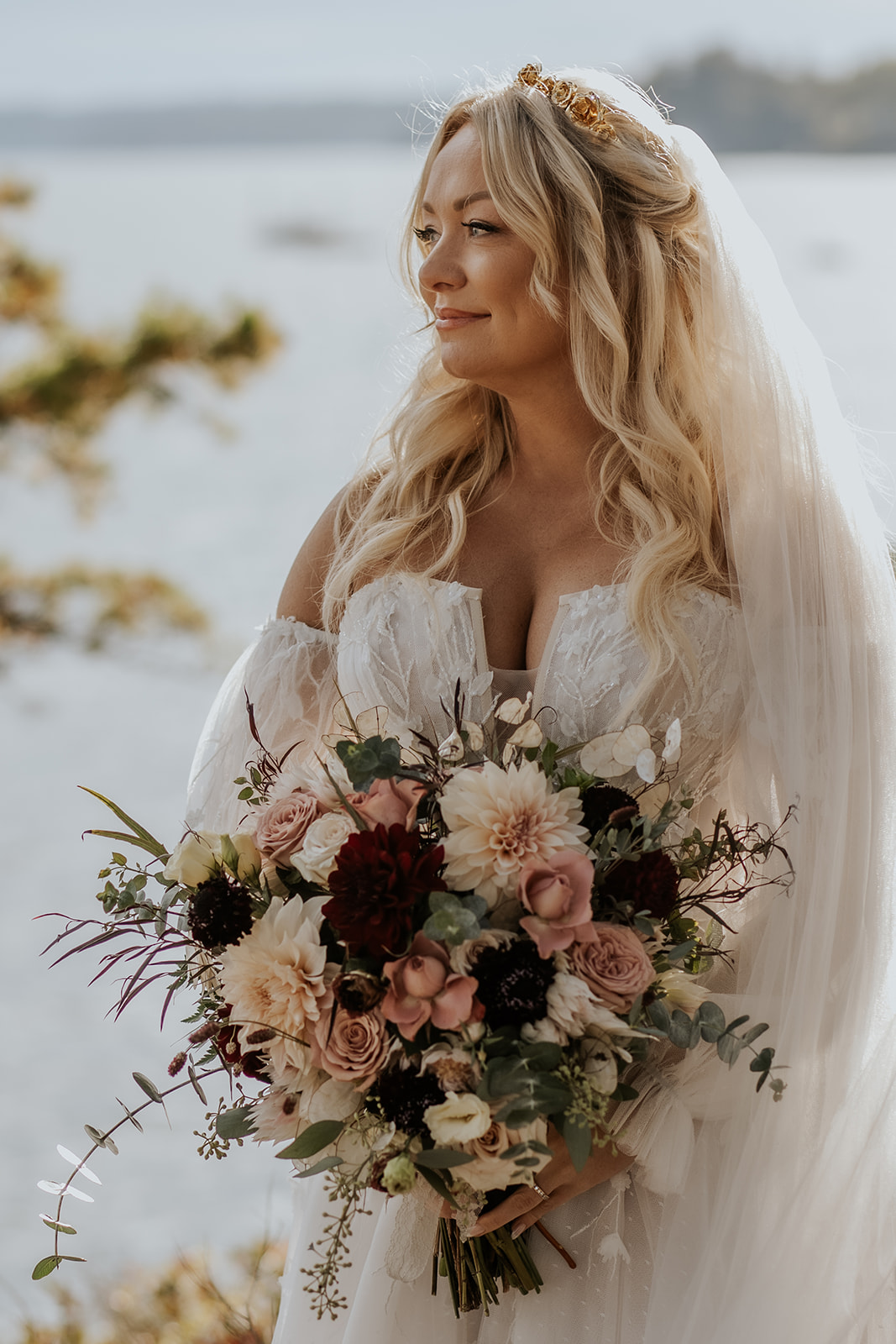 Fall bride portrait in Maine holding a plum and pink bridal bouquet.
