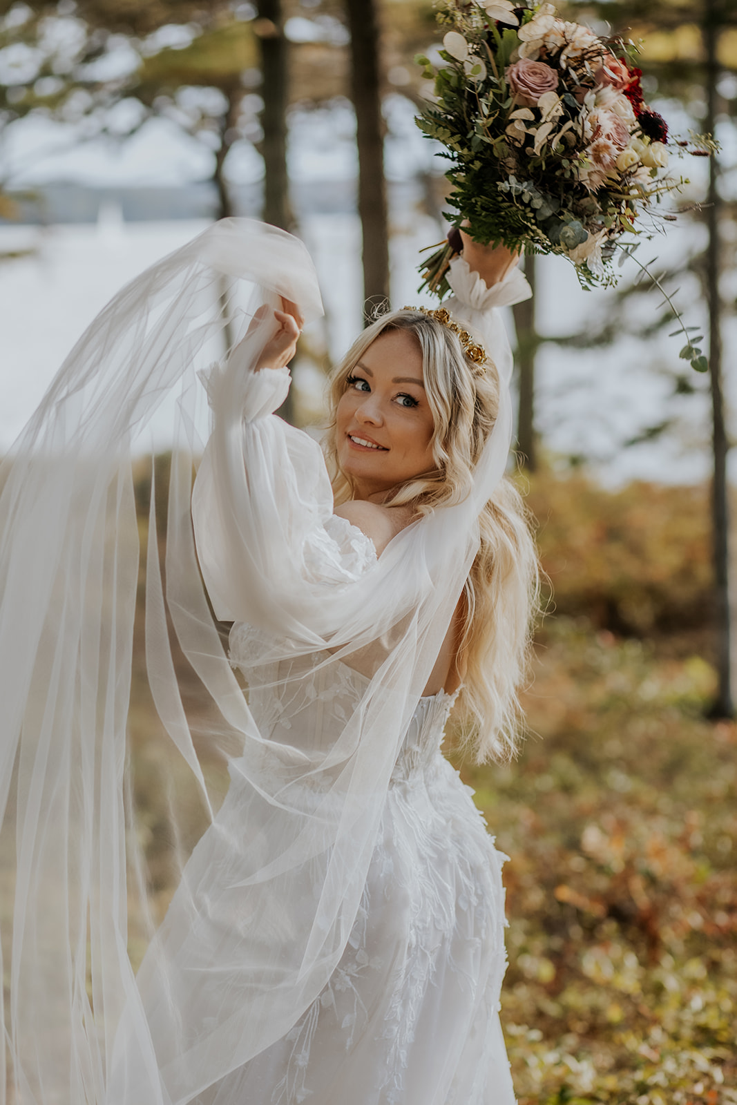 Bridal portrait with long veil and fall floral bouquet.