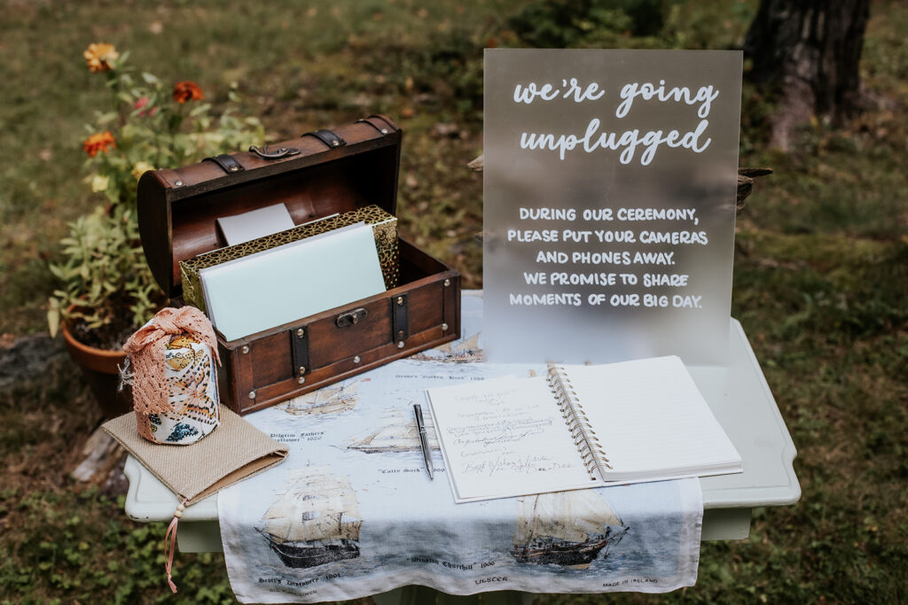 Unplugged frosted glass wedding ceremony sign and welcome table.