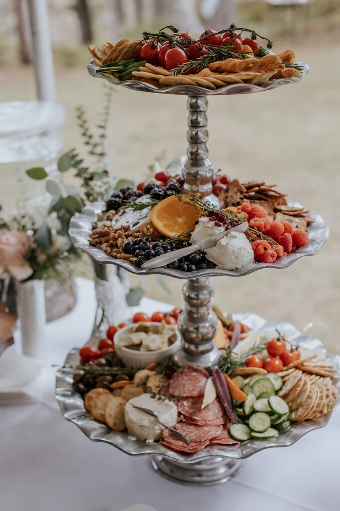 Wedding reception charcuterie board on a tiered platter.