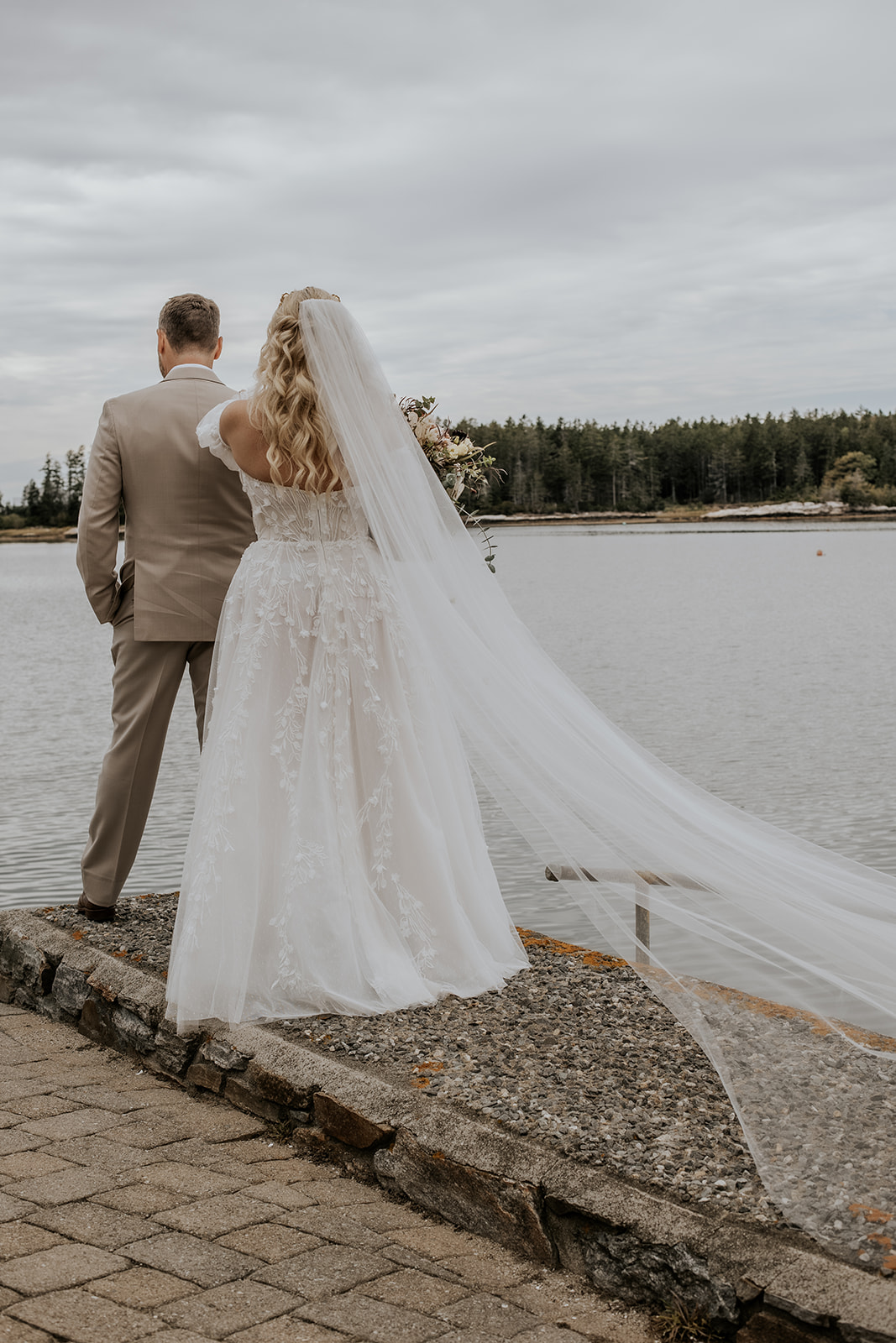 Bride and groom first look on a dock in Maine.