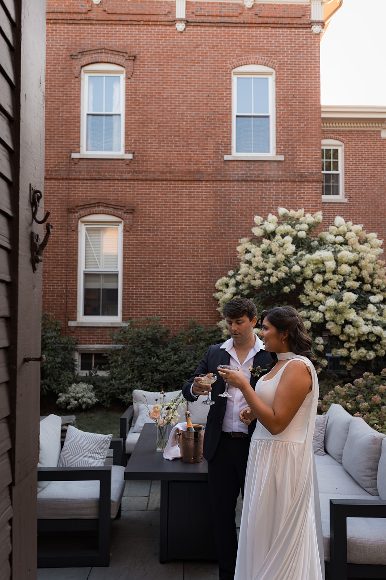 The newlyweds enjoying a quiet champagne toast outside a Historic Wedding Venue.