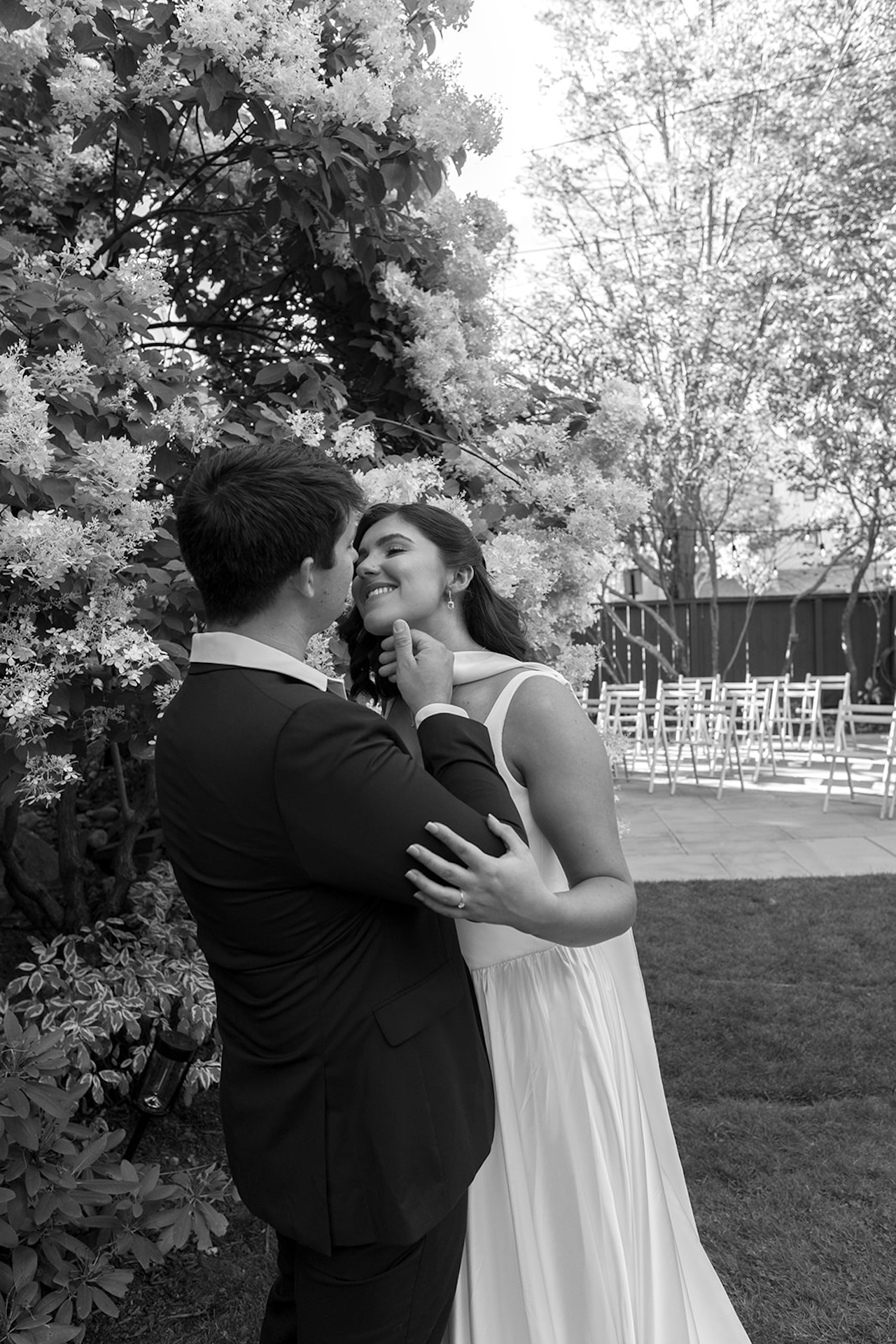 Bride smiling up at the groom during a quiet moment in the garden of one of Maine’s Historic Wedding Venues.