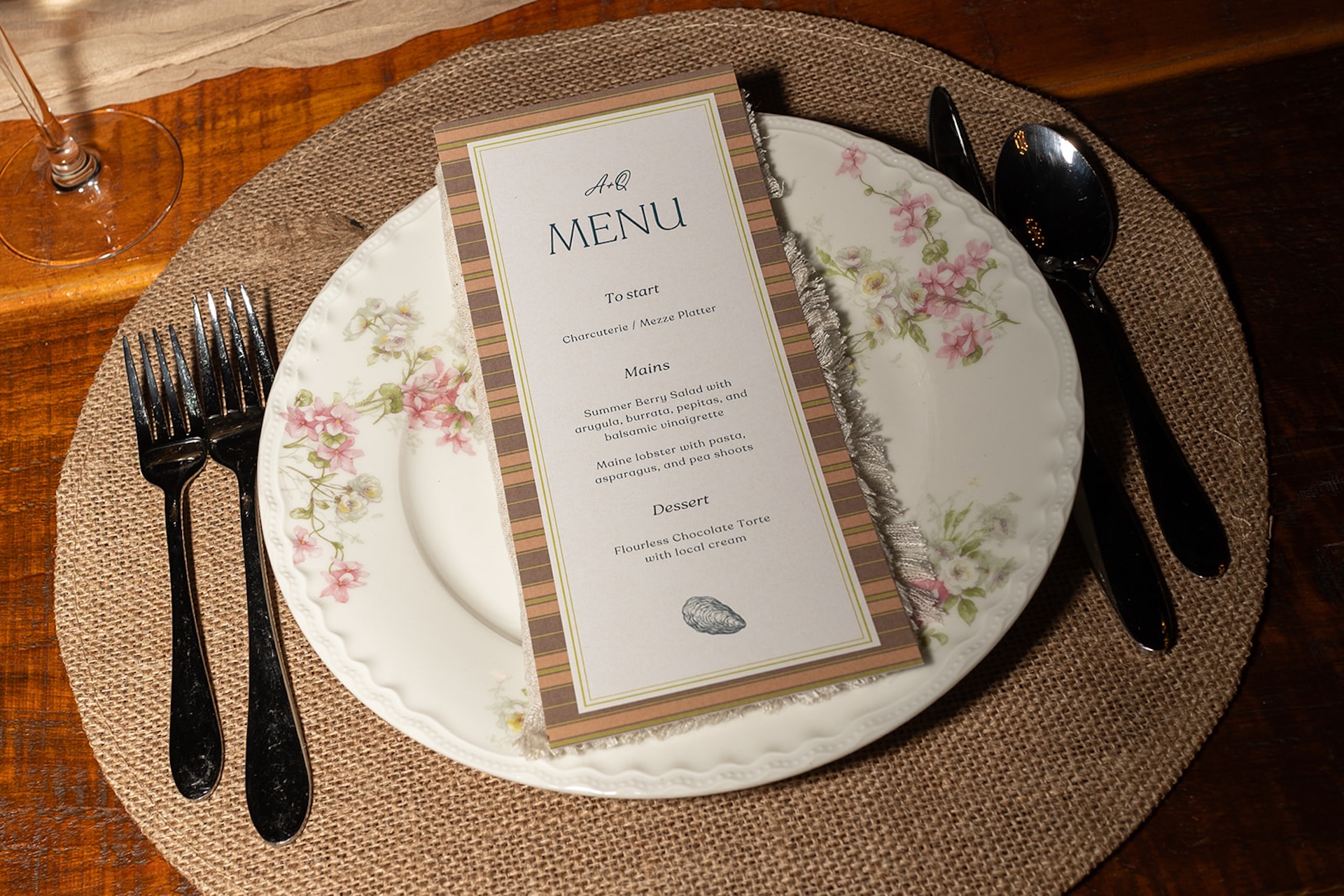 Close-up of the floral dinner menu placed on vintage china at a Historic Wedding Venue.