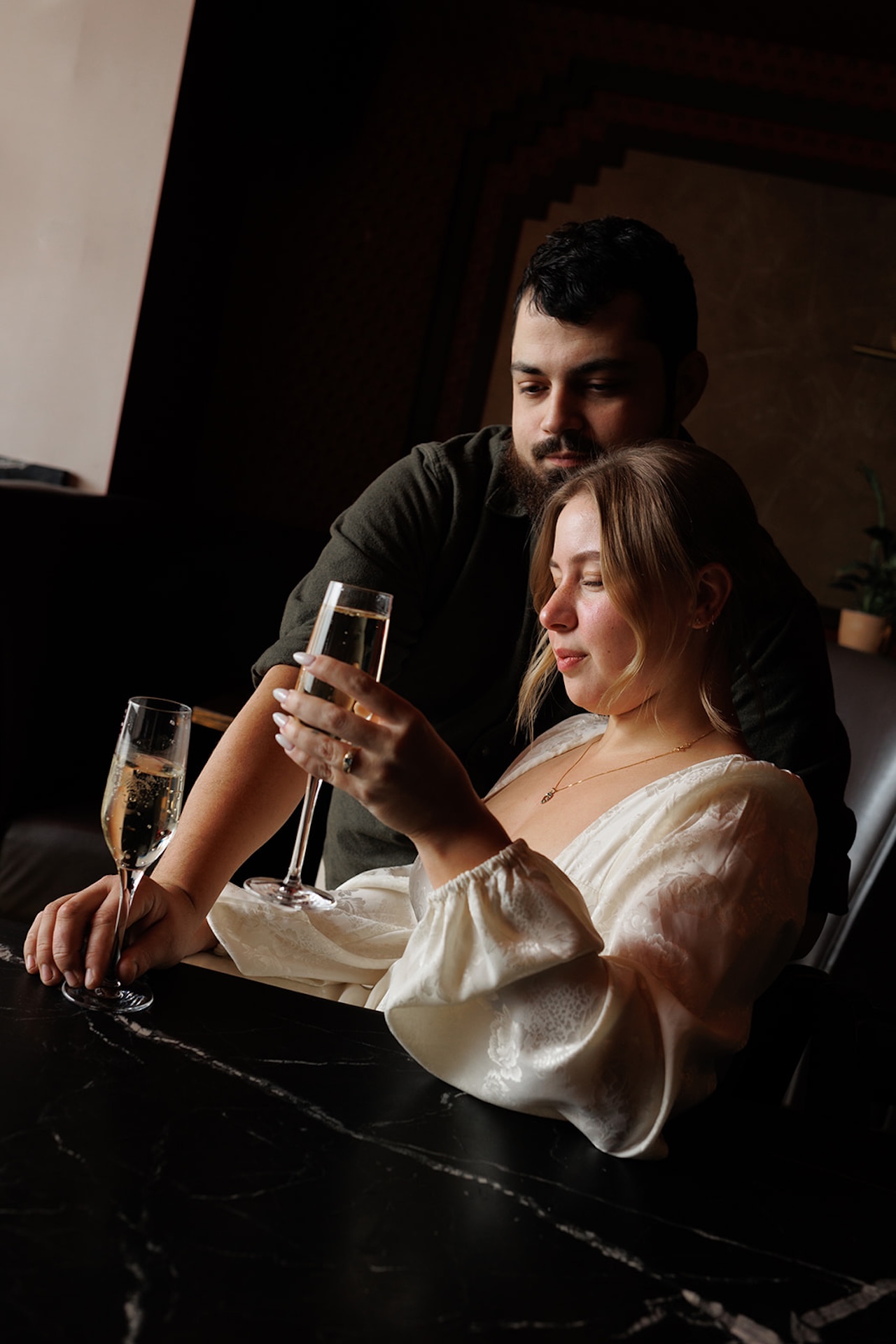 Engagement Photo Session Ideas: A couple sitting at a bar for a unique twist on engagement locations
