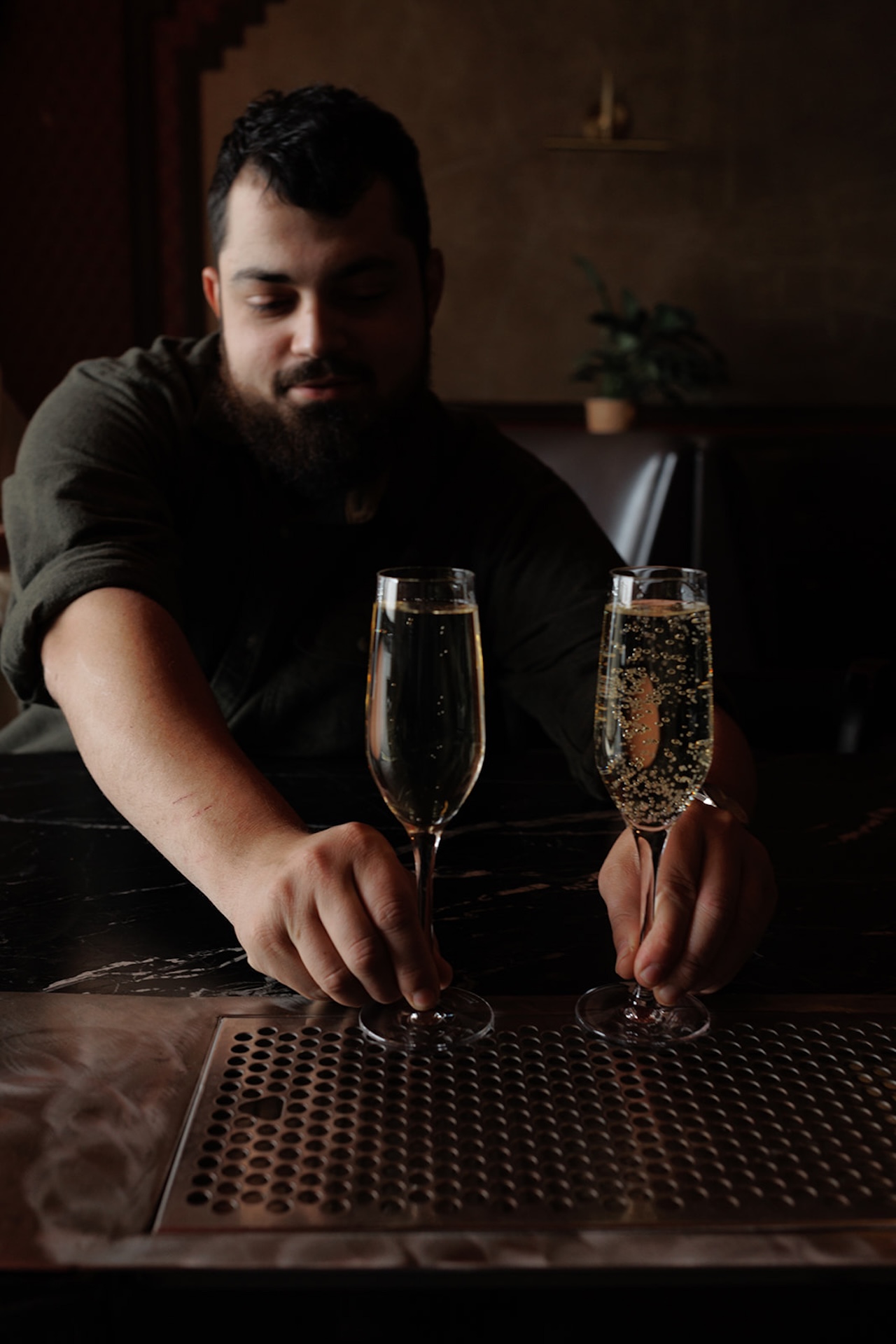 The groom to be grabbing the drinks at the bar for a unique detail shot.