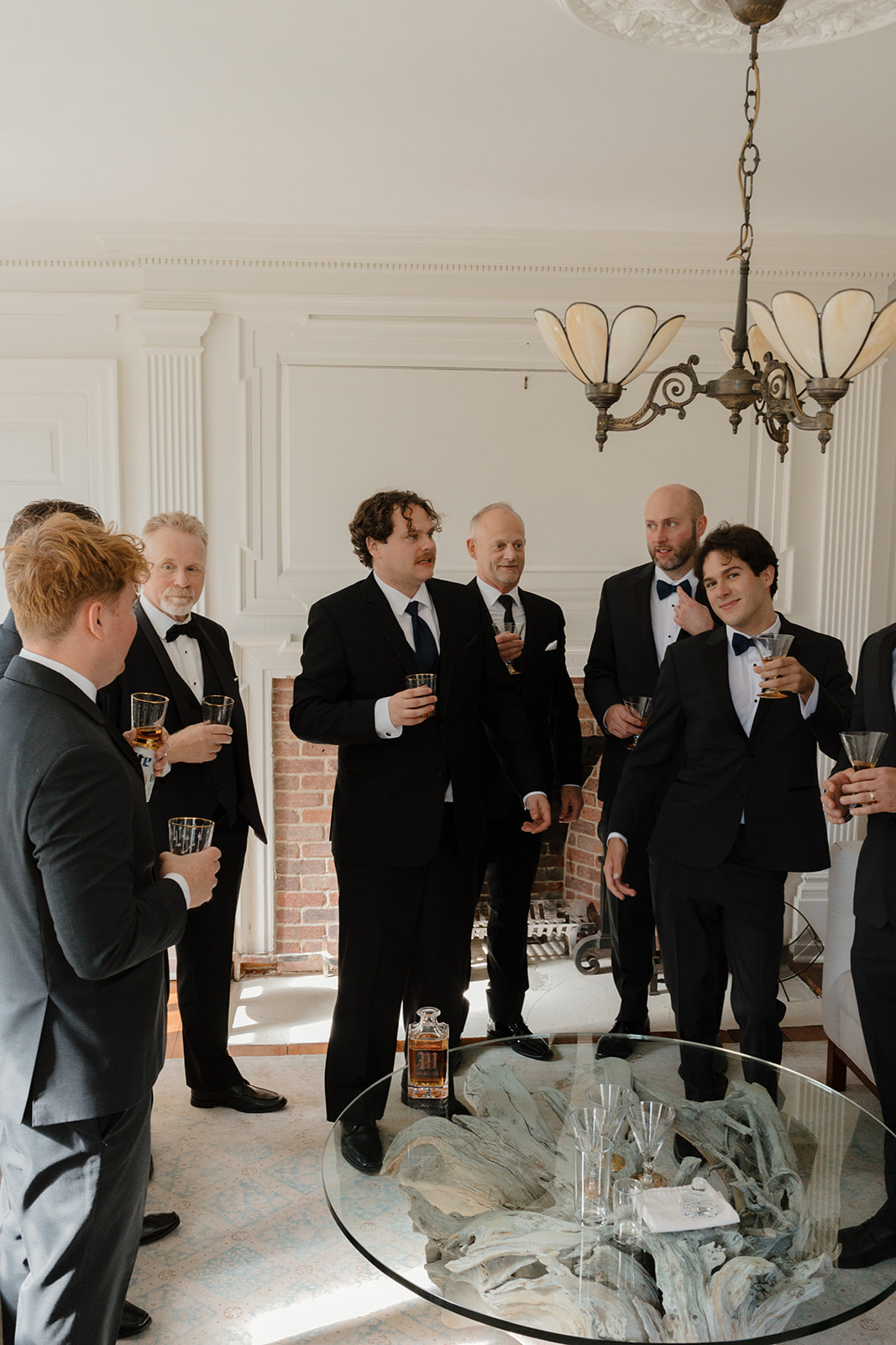 The groom, groomsmen, and family  all visiting while getting ready for a Destination wedding in Maine.