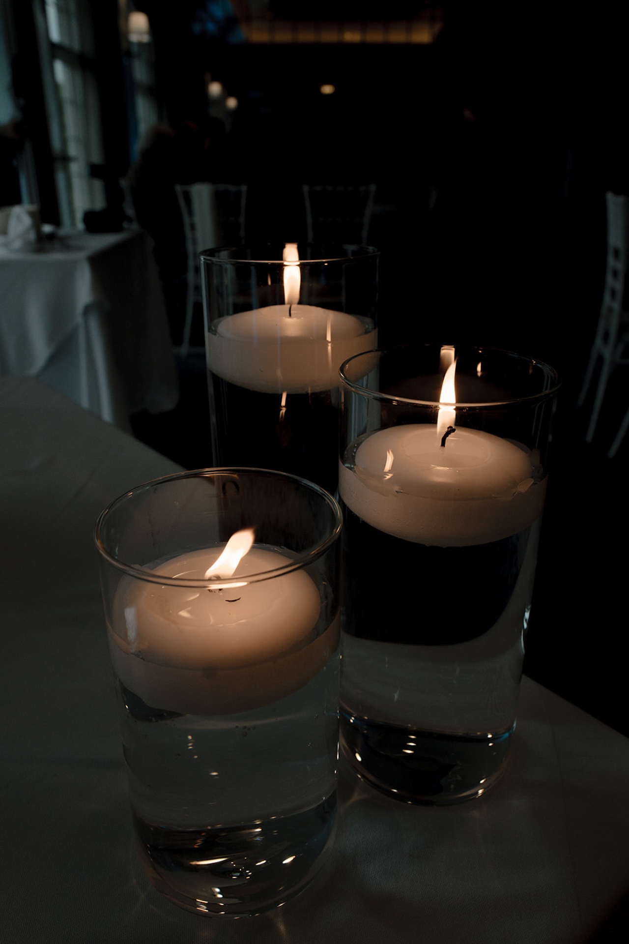 Floating candles in glass vases creating romantic reception lighting at Stage Neck Inn.