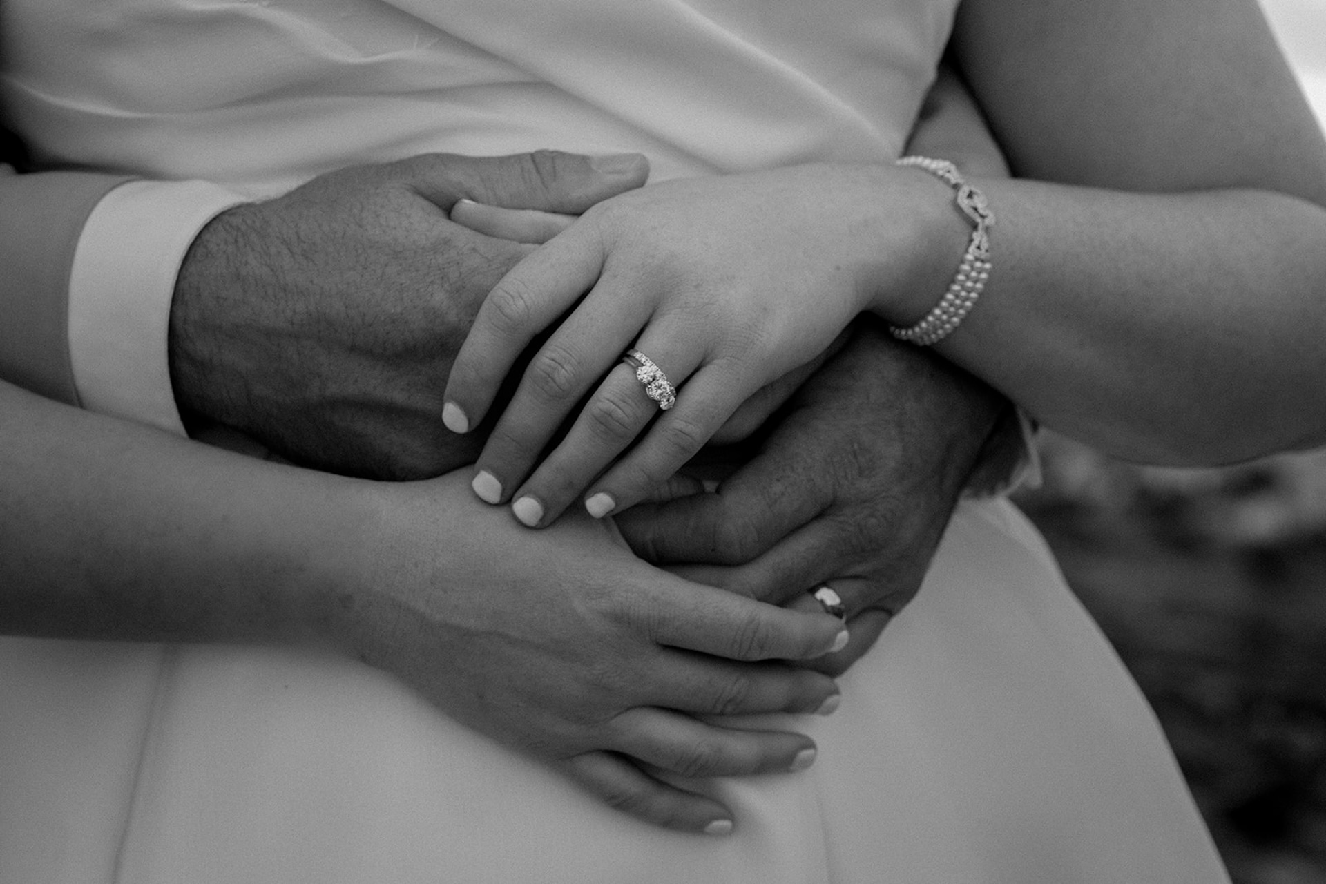 Close up of bride and groom hands showing wedding rings during a romantic portrait at Stage Neck Inn.