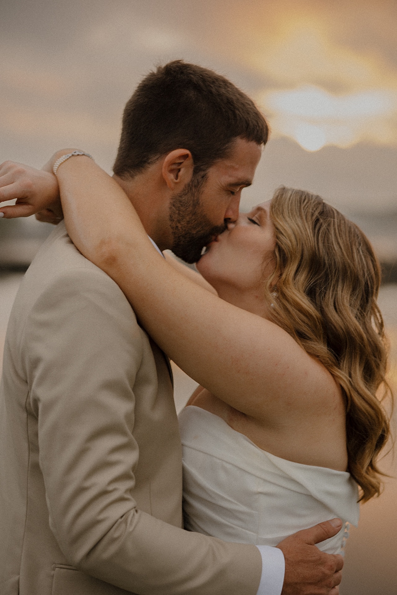 Bride and groom sharing a sunset kiss by the water at Stage Neck Inn in York, Maine.