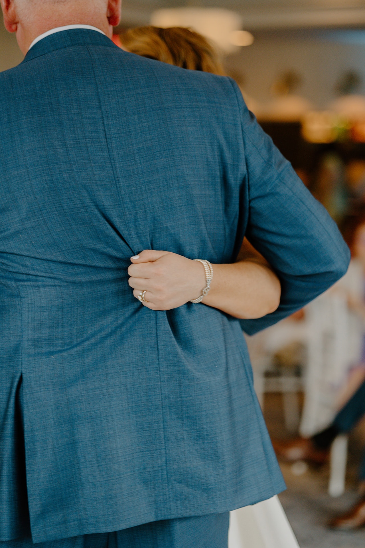 Close up of bride hugging her father during their emotional father daughter dance.
