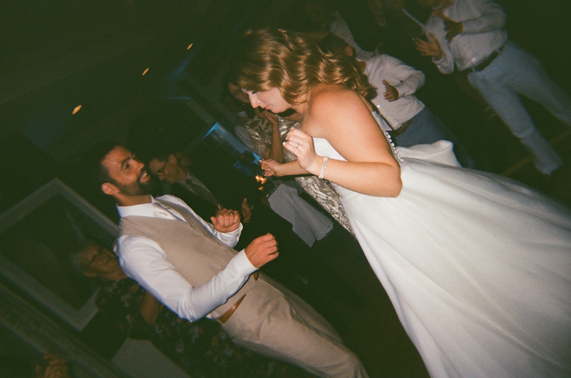 Bride and groom celebrating and dancing on the dance floor during their wedding reception.
