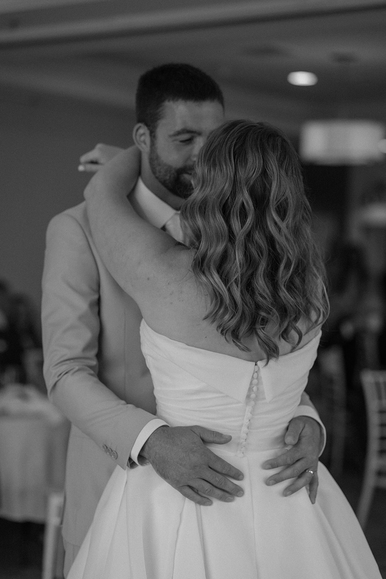 Black and white portrait of bride and groom embracing during their first dance at Stage Neck Inn.