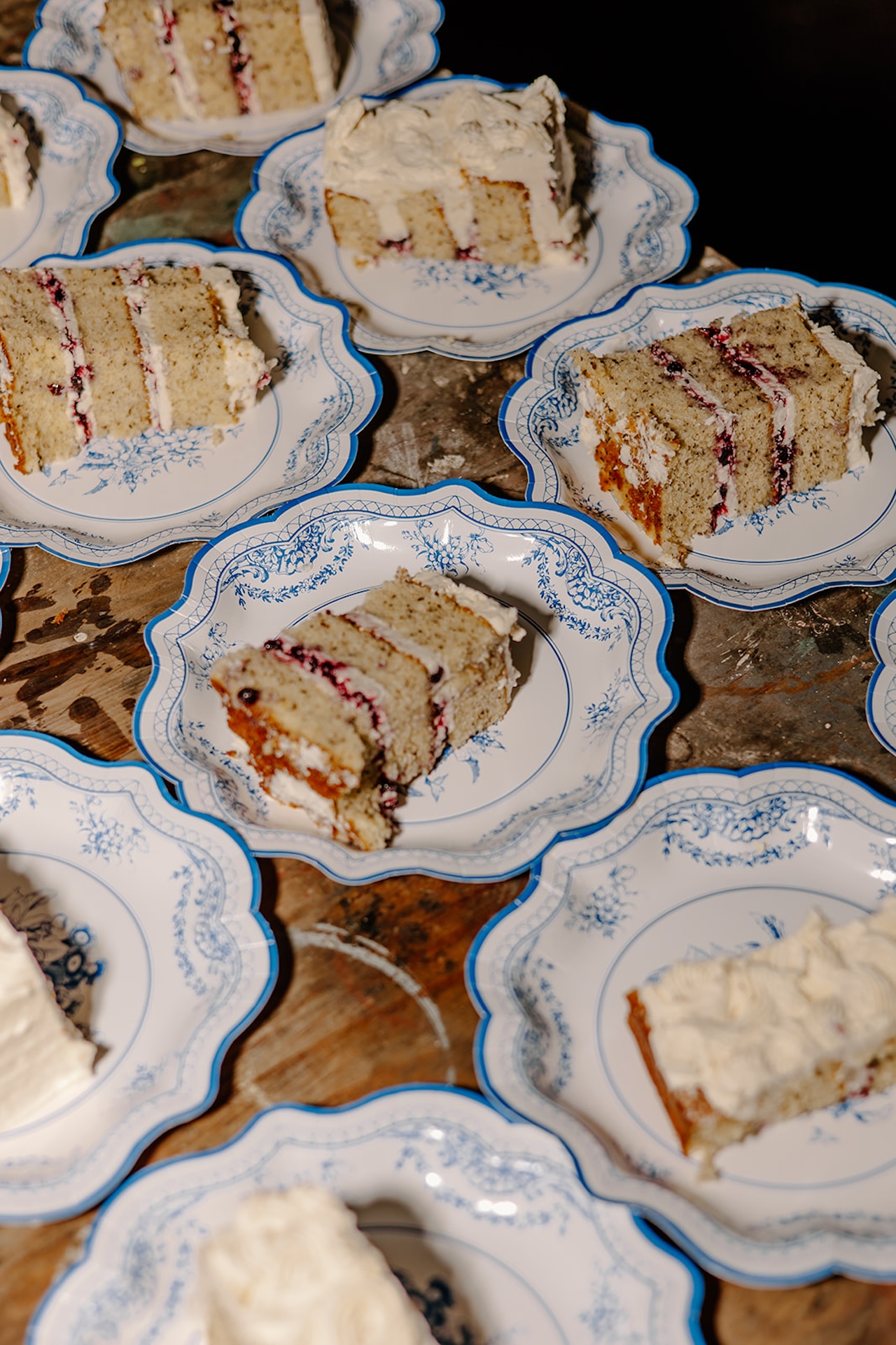 Wedding cake detail from a colorful weddings reception with vibrant raspberry jam and frosting.