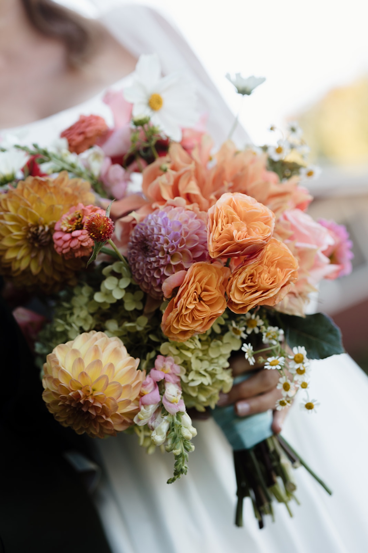 Colorful wedding bouquet featuring vibrant pink and orange flowers