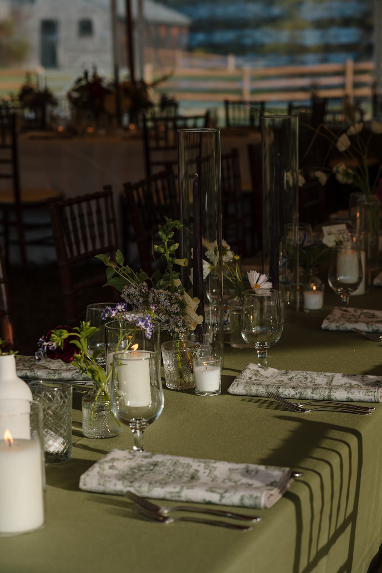 Reception tablescape with candles and florals during a colorful weddings celebration