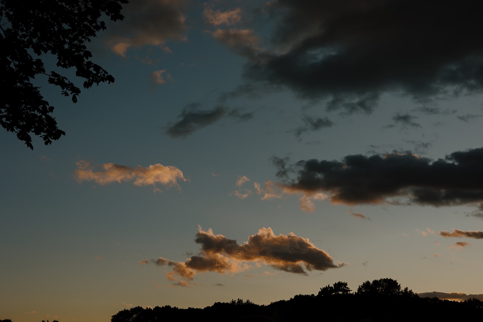 A dark sunset sky with oranges and blues.