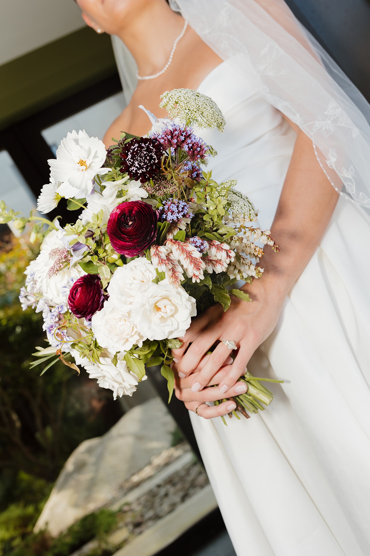 Bridal portraits with the brides dress details while she holds a bright floral bouquet, perfect inspiration for colorful weddings.