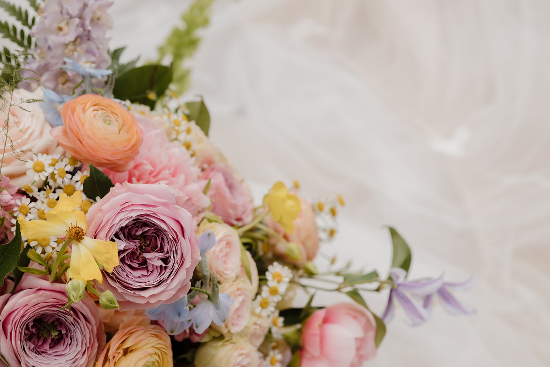 Close-up of bright wedding florals arranged in a colorful bouquet