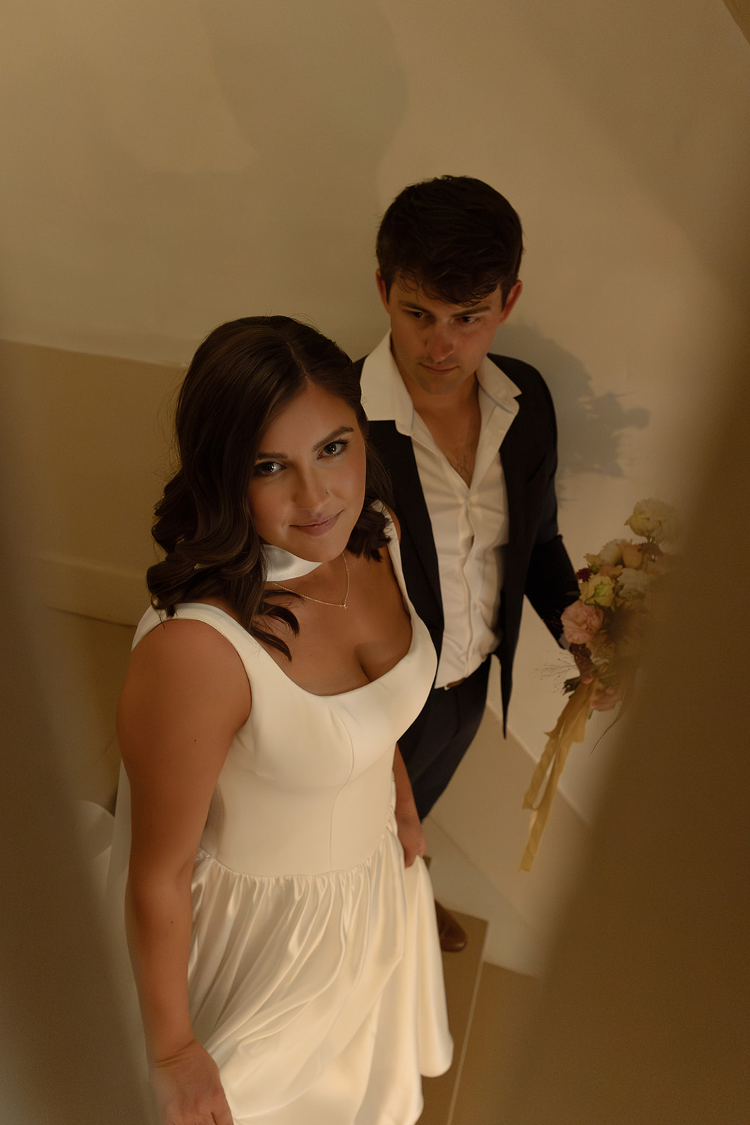 Couple holding hands during intimate wedding moment