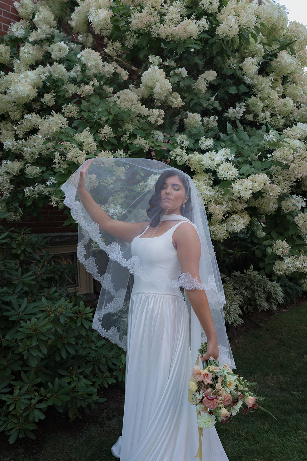 Bride lifting veil during an intimate wedding