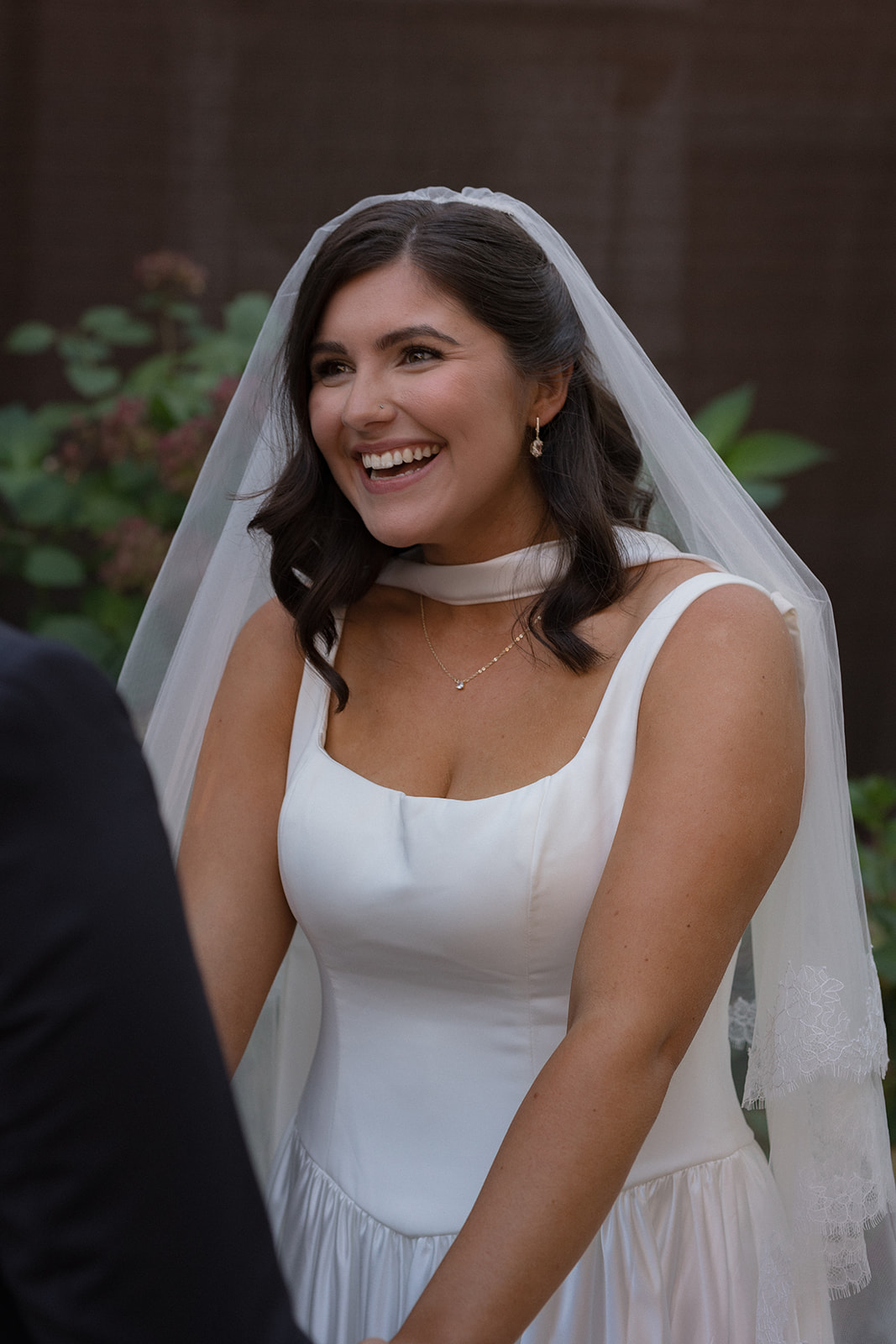 Bride laughing during an intimate wedding ceremony