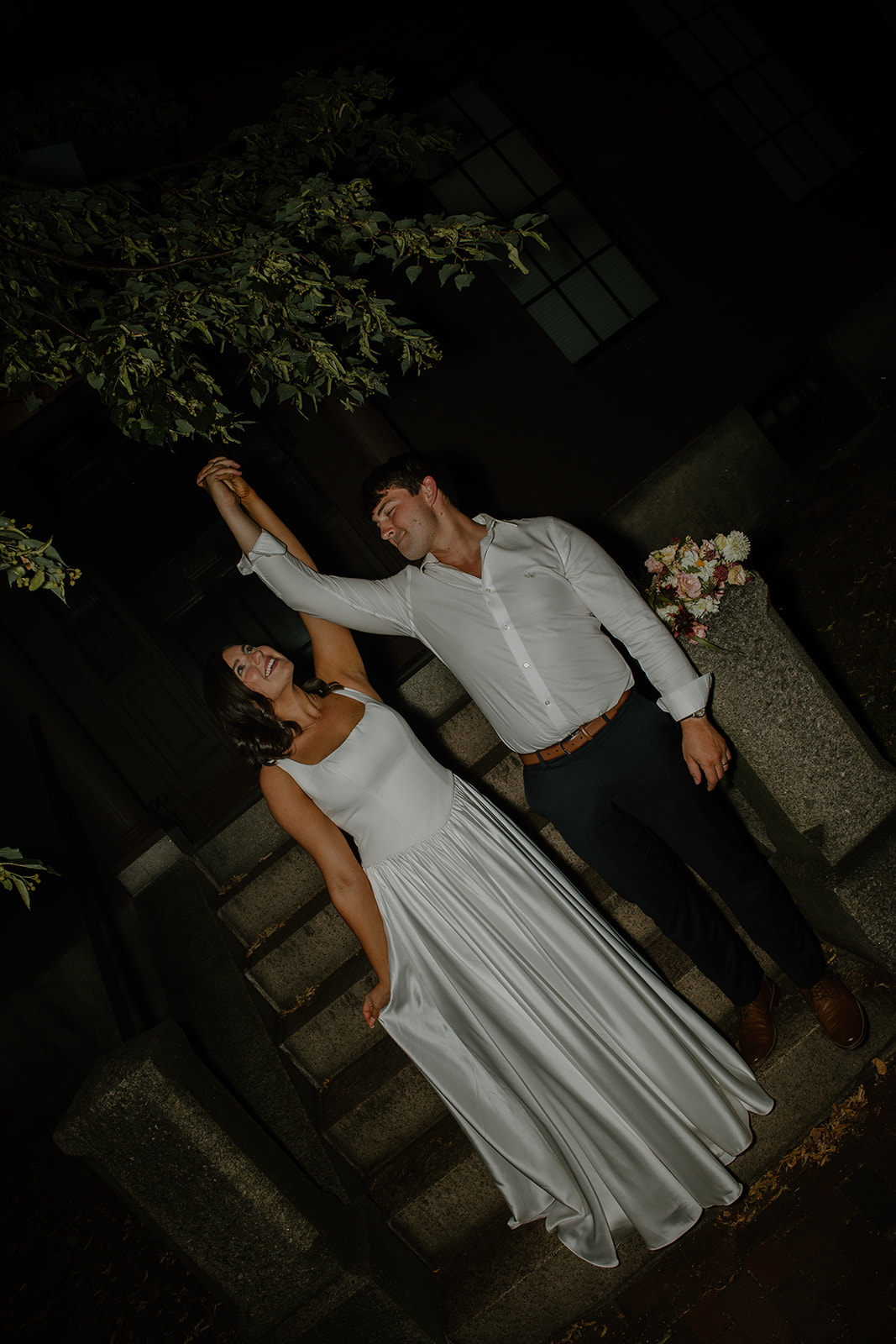 Playful couple dancing during an intimate wedding night