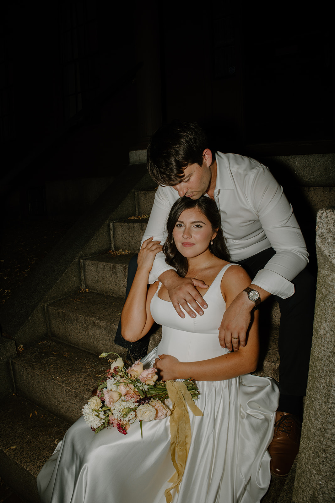 Groom embraces bride during an intimate wedding portrait