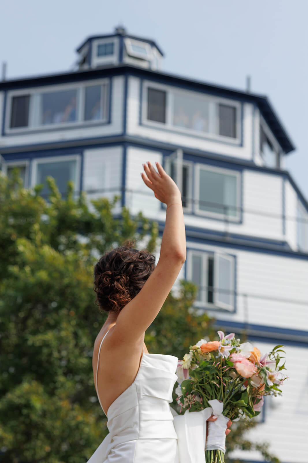 Bride holding a colorful bouquet outside a coastal Maine wedding venue moments before the ceremony.